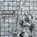 a close up of a statue of a person holding a baseball bat