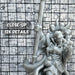a close up of a statue of a person holding a baseball bat