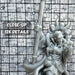 a close up of a statue of a person holding a baseball bat