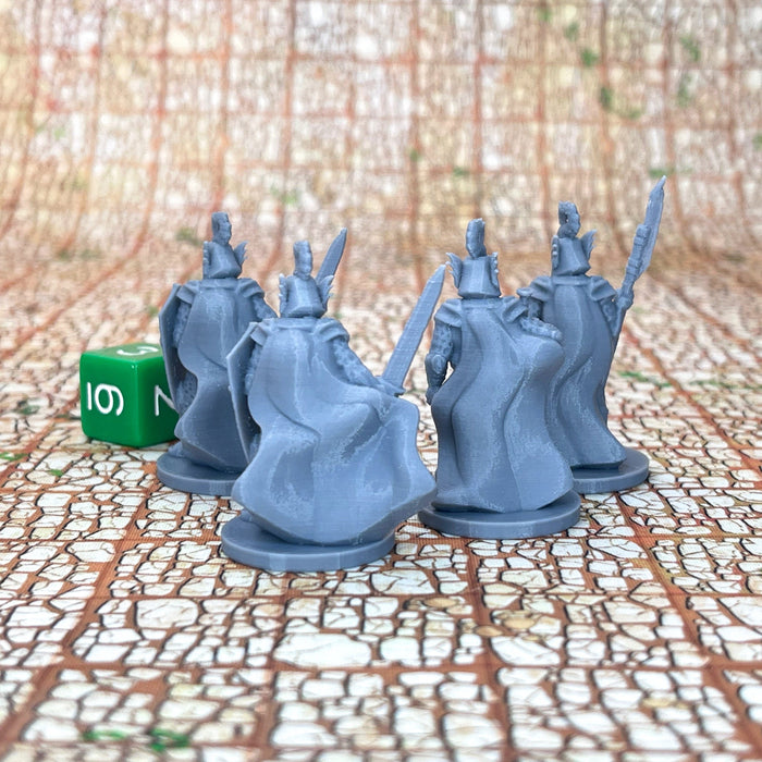 a couple of blue plastic figures sitting on top of a table