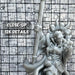 a close up of a statue of a person holding a baseball bat