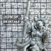 a close up of a statue of a person holding a baseball bat