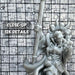 a close up of a statue of a person holding a baseball bat