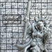 a close up of a statue of a person holding a baseball bat